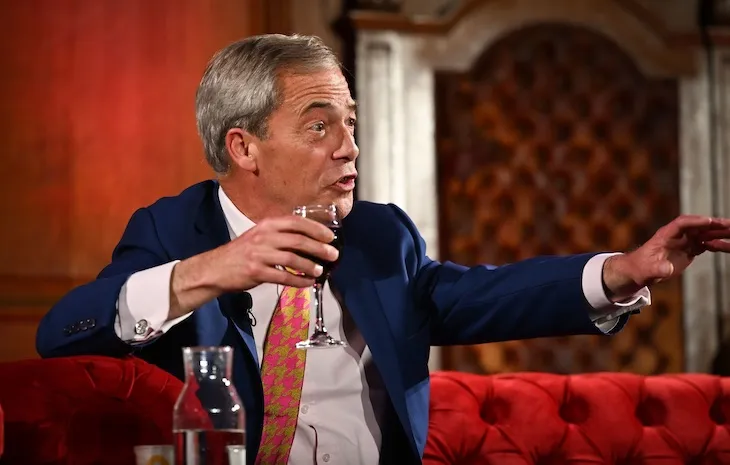 Nigel Farage drinking in the British Parliament